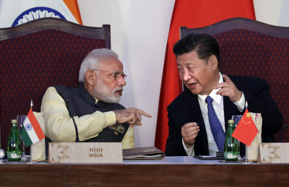 FILE - In this Oct. 16, 2016, file photo, Indian Prime Minister Narendra Modi, left, talks with Chinese President Xi Jinping at the signing ceremony by foreign ministers during the BRICS summit in Goa, India. India’s Ministry of External Affairs said Wednesday, Oct. 9, 2019, that Xi and Modi would meet for a second informal summit in the southern coast city of Chennai on Oct. 11 and 12 to “exchange views on deepening” the two countries’ development. (AP Photo/Manish Swarup, File)