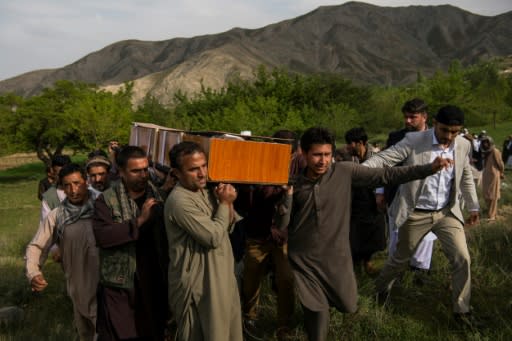 Relatives and friends of late AFP photographer Shah Marai carry his coffin at his burial outside Kabul