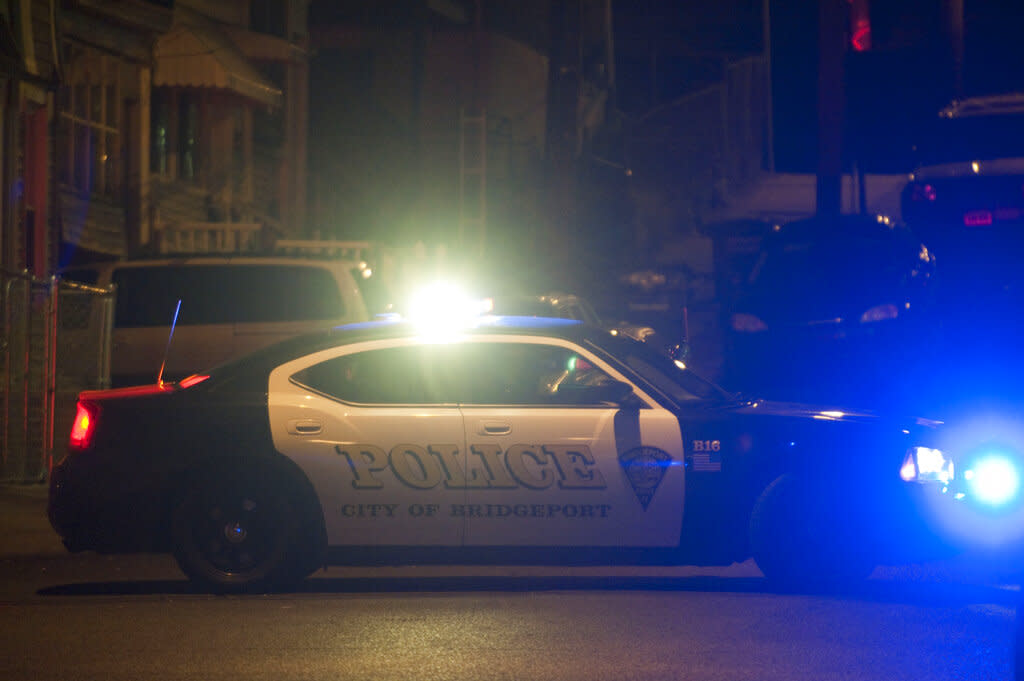 A Bridgeport, Connecticut, police car blocks a street at night. 