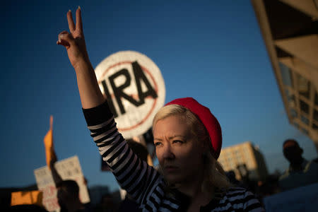 An activist gives a peace sign while taking part in a protest march against the National Rifle Association (NRA) in Dallas, Texas, U.S., May 4, 2018. REUTERS/Adrees Latif