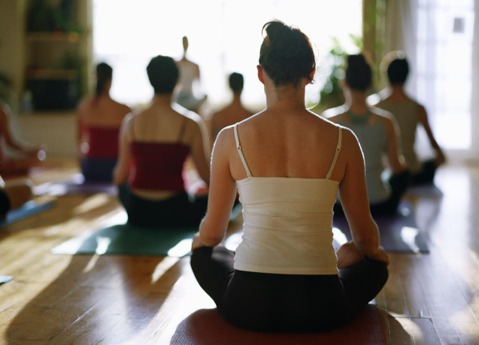 people wearing tank tops in yoga class