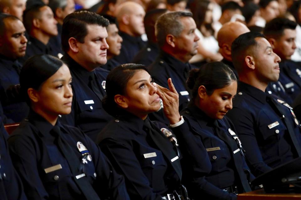 A Los Angeles Police officer wipes away tears during the memorial service for fellow officer Juan J. Diaz during his funeral mass at the Cathedral of Our Lady of the Angels in Los Angeles, Calif., on Monday, Aug. 12, 2019. (Al Seib/Los Angeles Times via AP)