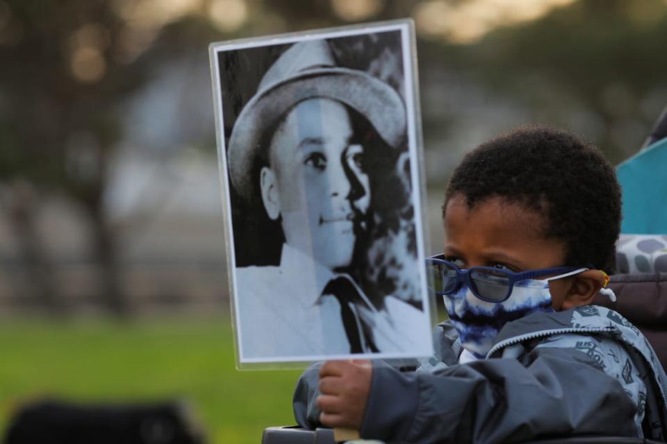 <div class="inline-image__caption"><p>A protester holds up a photo of Emmett Till during a vigil for George Floyd in 2021. </p></div> <div class="inline-image__credit">REUTERS/Brian Snyder</div>