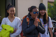 Nepalese climber Lhakpa Sherpa gestures as she arrives at the airport in Kathmandu, Nepal, Tuesday, May 17, 2022. The Nepali Sherpa broke her own record reaching the 8,849-meter (29,032-foot) summit for a 10th time — the most times any woman has climbed Mount Everest. Sherpa, 48, said she is next planning to scale the world's second-highest peak, K2 in Pakistan. (AP Photo/Niranjan Shrestha)