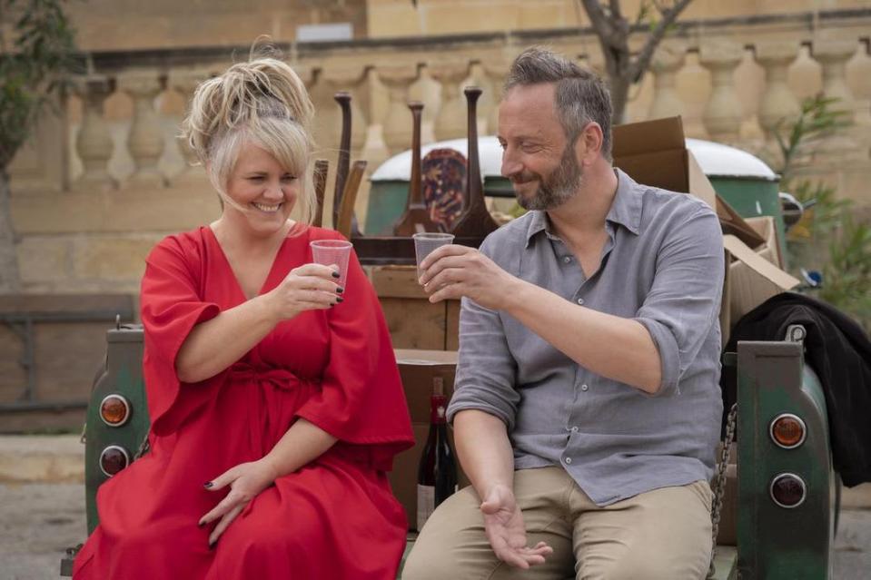 Jean and Dom toast in The Madame Blanc Mysteries