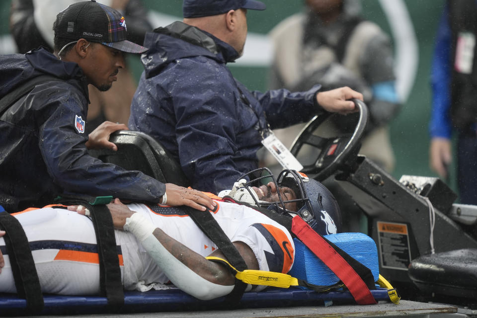 Denver Broncos running back Tyler Badie (28) is taken off the field after sustaining an injury against the New York Jets during the second quarter of an NFL football game on Sunday, September 29, 2024, in East Rutherford, NJ (AP Photo/Bryan). Woolston)