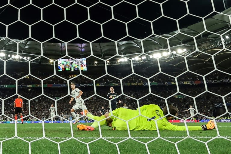 Hungary forward Kevin Csoboth (L) scores against Scotland (LLUIS GENE)