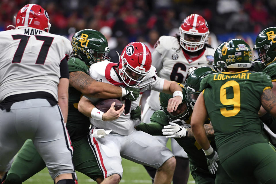 Georgia quarterback Jake Fromm (11) is sacked by Baylor defensive tackle Bravvion Roy in the second half of the Sugar Bowl NCAA college football game in New Orleans, Wednesday, Jan. 1, 2020. (AP Photo/Bill Feig)