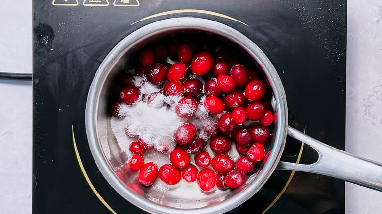 cranberries and sugar in saucepan