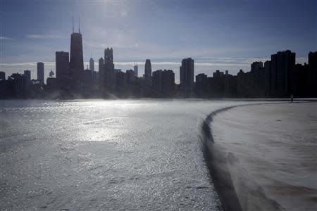 Ice covers the shore of Lake Michigan in Chicago where temperatures have dropped well below freezing, December 12, 2013. REUTERS/John Gress