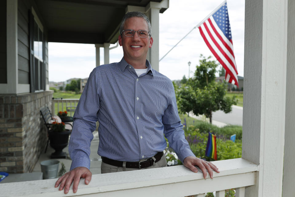 In this Monday, July 1, 2019, photo, software engineer Joe Wilson poses for a photo outside his home in Highlands Ranch, Colo. The tariffs that the Trump administration has placed on thousands of products imported from China and retaliatory duties placed on U.S. goods are affecting many small businesses, even if they’re not importers or exporters. Wilson might have to put off hiring freelancers if he feels the ripple effects of tariffs that his customers must pay. (AP Photo/David Zalubowski)
