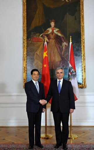 Austrian chancellor Werner Faymann (R) shakes hands with Chinese President Hu Jintao before their meeting in Vienna. China pledged "active support" to debt-stricken Europe and said it was "convinced" the EU could work through its current debt crisis, as Hu visited Vienna on Monday ahead of a G20 meeting