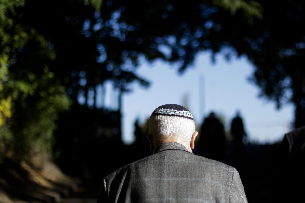 FILE - In this Thursday, Oct. 18, 2012 photo a man with a Kippa walks up the ramp to Platform 17 (Gleis 17) to attend an hour of commemoration in Berlin. The dictionary of standard High German has changed its definition of Jews, or Jude in German. The Duden dictionary had recently added an explanation to its online edition saying “occasionally, the term Jew is perceived as discriminatory because of the memory of the National Socialist use of language. In these cases, formulations such as Jewish people, Jewish fellow citizens or people of the Jewish faith are usually chosen.” The explanation caused an uproar in the country’s Jewish community. (AP Photo/Markus Schreiber, file)