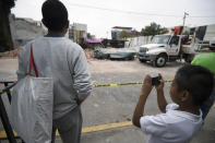 <p>A boy takes pictures of a knocked down building at the eastern area of Mexico City after a 8,2 earthquake on Sept. 8, 2017. (Photo: Alfredo Estrella/AFP/Getty Images) </p>