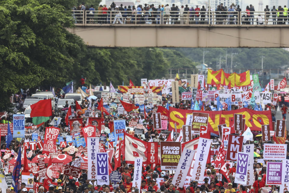 Protesters march along the main road heading to the House of Representatives in Quezon City, Philippines, Monday, July 24, 2023, ahead of the second State of the Nation Address of Philippine President Ferdinand Marcos Jr. (AP Photo/Gerard Carreon)