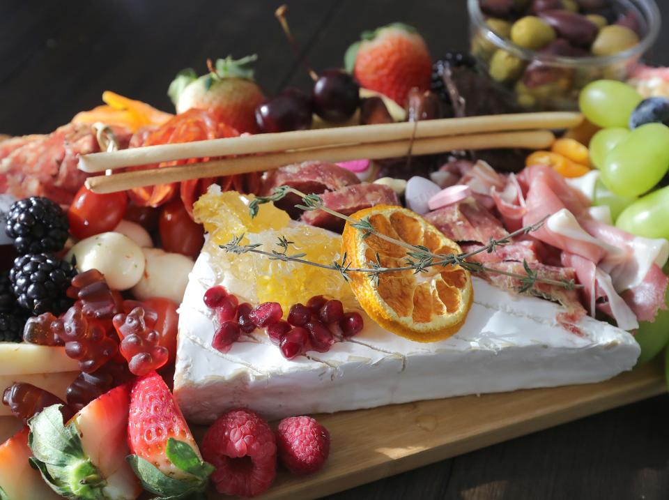 Angela Warren, owner of The Moorer the Merrier Grazing, blends flavor and color on her custom charcuterie boards.