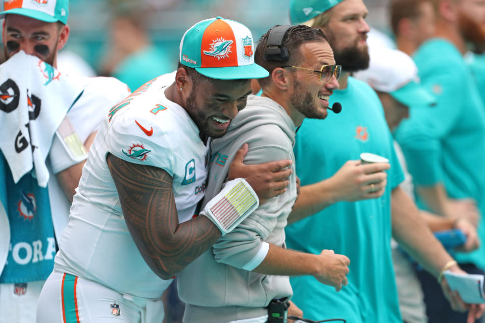 Miami Dolphins quarterback Tua Tagovailoa (1) laughs with head coach Mike McDaniel during action against the Denver Broncos at Hard Rock Stadium on Sept. 24, 2023, in Miami Gardens, Florida. (John McCall/South Florida Sun Sentinel/Tribune News Service via Getty Images)