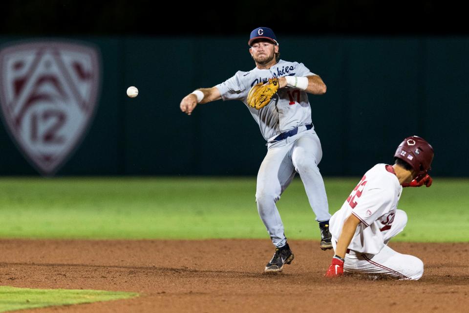 Connecticut second baseman David Smith, left, throws to first base after forcing out Stanford's Eddie Park (22) during the fourth inning of an NCAA college baseball tournament super regional game Saturday, June 11, 2022, in Stanford, Calif.