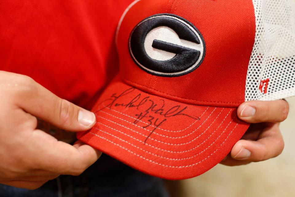 A UGA hat Republican Senate candidate Herschel Walker signed for a supporter at the Northeast Georgia Livestock Barn in Athens, Ga., on Wednesday, July 20, 2022. Walker spoke about gas prices and the November election. 