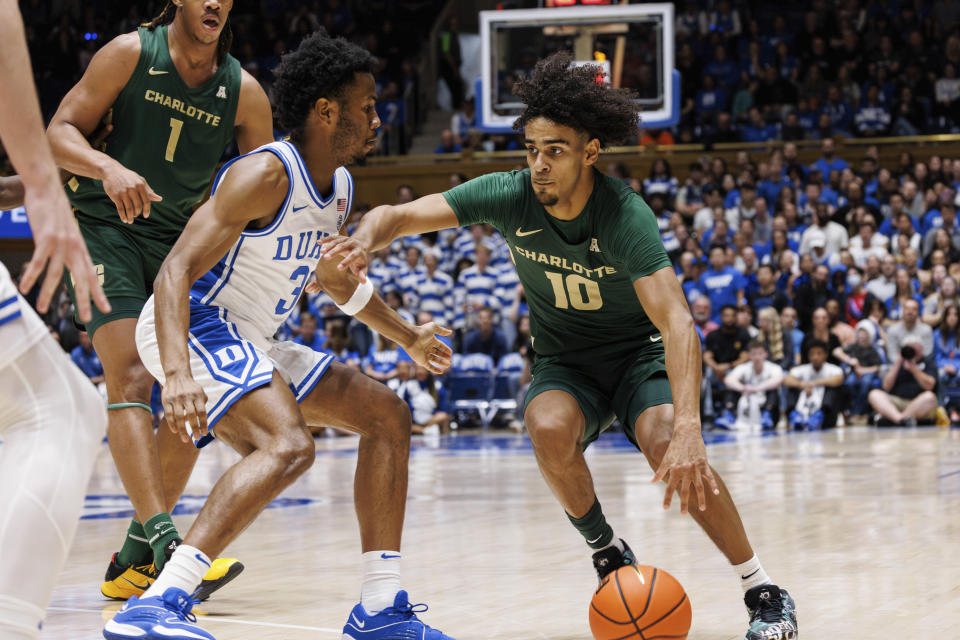 Charlotte's Nik Graves (10) handles the ball as Duke's Jeremy Roach (3) defends during the first half of an NCAA college basketball game in Durham, N.C., Saturday, Dec. 9, 2023. (AP Photo/Ben McKeown)