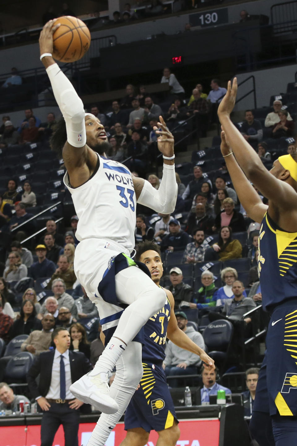 Minnesota Timberwolves' Robert Covington, left, shoots as Indiana Pacers' Myles Turner defends in the first half of an NBA basketball game Wednesday, Jan. 15, 2020, in Minneapolis. (AP Photo/Jim Mone)
