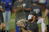 Los Angeles Dodgers third baseman Justin Turner celebrates with the trophy after defeating the Tampa Bay Rays 3-1 to win the baseball World Series in Game 6 Tuesday, Oct. 27, 2020, in Arlington, Texas. (AP Photo/Eric Gay)