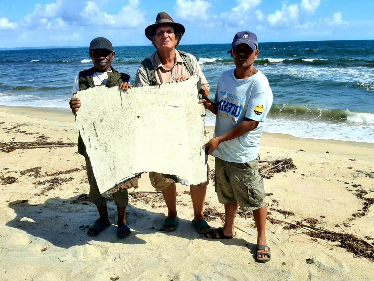 American MH370 wreckage hunter Blaine Gibson with the damaged landing gear door in Madagascar (Blaine Gibson & Richard Godfrey report)