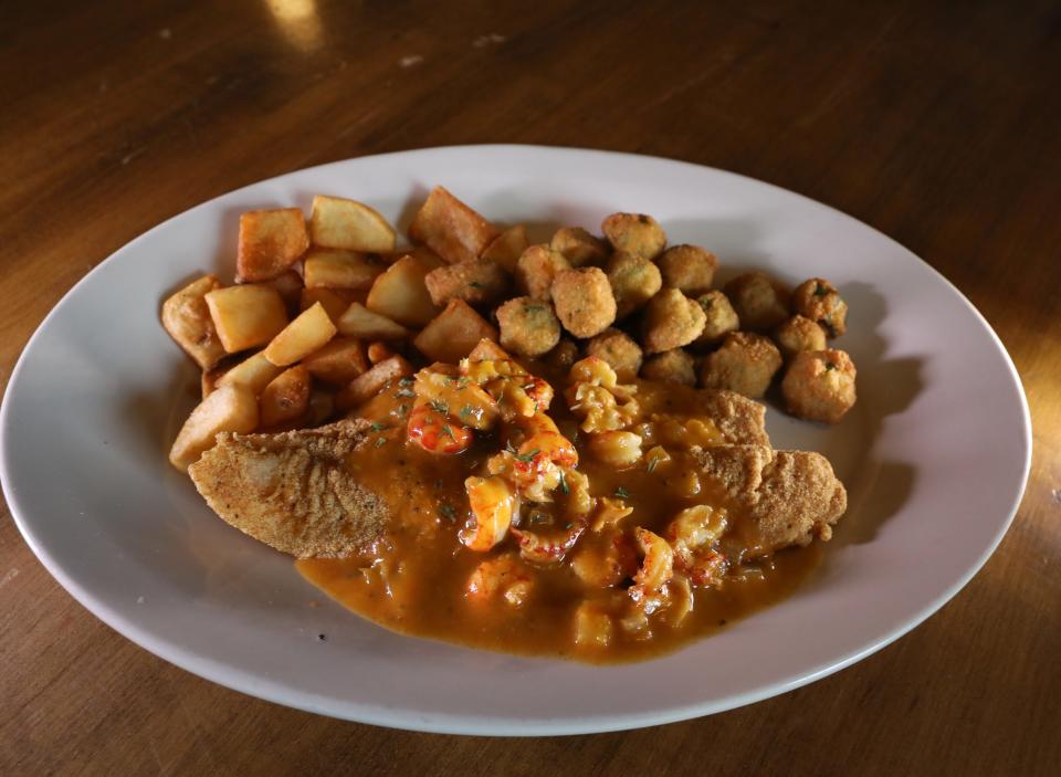 Deep fried catfish is topped with crawfish étouffée to make the smothered catfish dish at The French Quarter in Rochester.