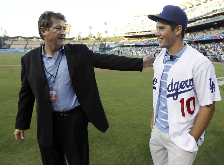 Los Angeles Dodgers assistant general manager Logan White, left, stands with the team's top draft pick, Zach Lee, before the Dodgers' baseball game against the Colorado Rockies in Los Angeles, Wednesday, Aug. 18, 2010. (AP Photo/Chris Carlson)