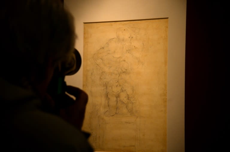 Visitors look at Michelangelo Buonarroti's drawing on paper in black pencil, red pencil and pen of 'The Sacrifice of Isaac' (Verso/back) in Rome's Capitolini Museums on April 21, 2017