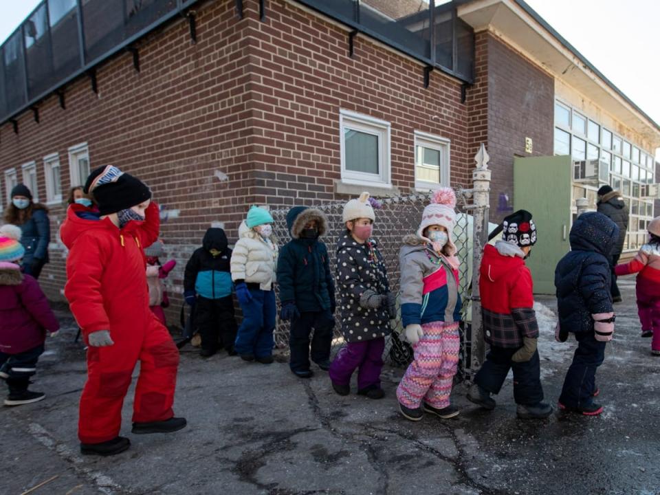 Whether or not Ontario students will return to in-person learning after the holiday break is uncertain, as the Omicron variant drives community transmission of COVID-19 to new heights. A kindergarten class in Toronto is pictured here on Feb. 25, 2021. (Evan Mitsui/CBC - image credit)