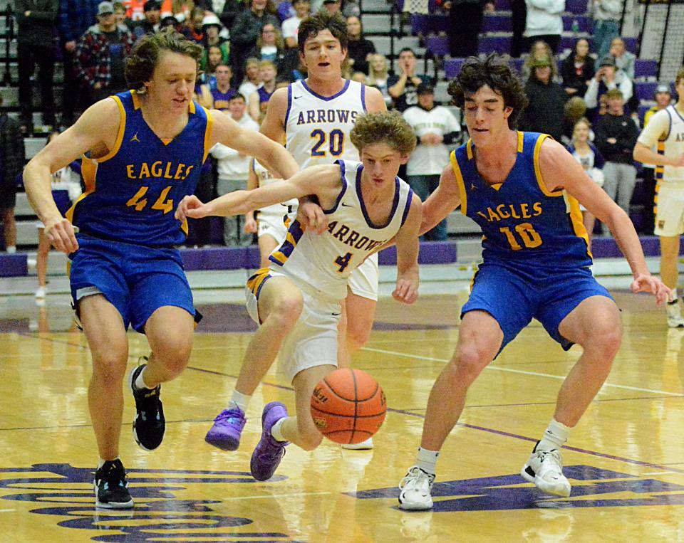 Aberdeen Central's Grant Fritz (44) and Parker Lemer (10)  challenge Watertown's Dylon Rawdon (4) for a loose ball during their high school boys basketball game on Tuesday, Jan. 10, 2023 in the Watertown Civic Arena. Watertown won 48-30. Trailing the play is Watertown's Jake Olson.