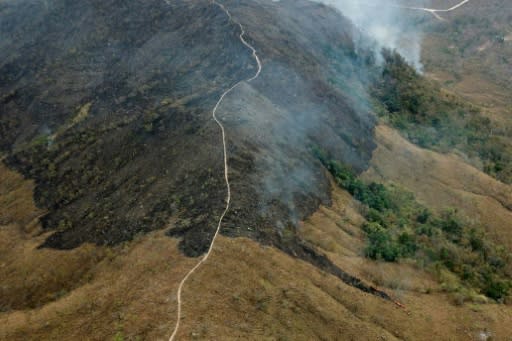 Handout aerial picture released by the Mato Grosso Fire Department showing burnt areas of land in the hills of the municipality of Chadapa dos Guimaraes in Mato Grosso State, in west-central Brazil, on August 23, 2019