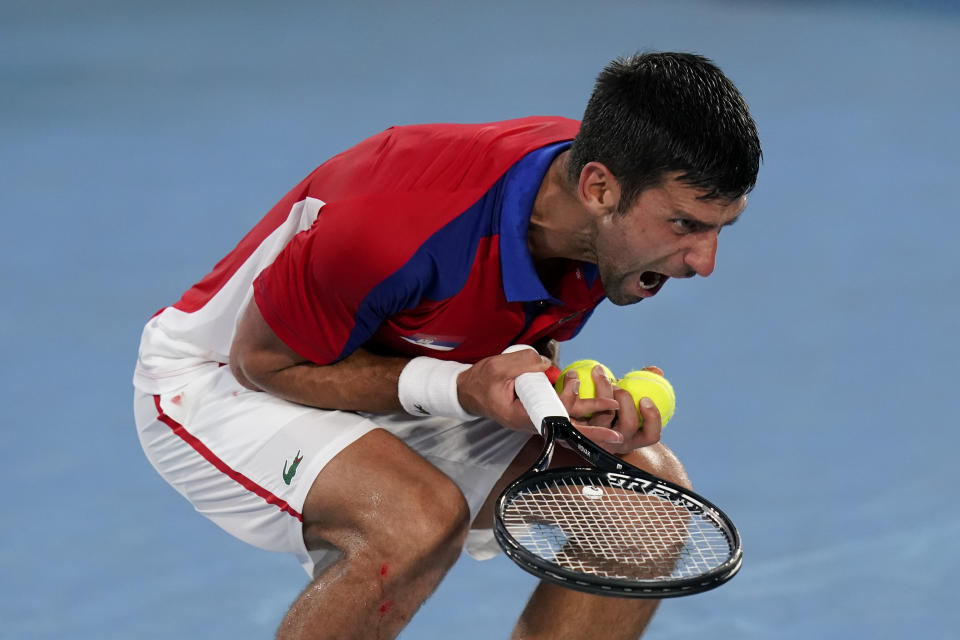 Novak Djokovic, of Serbia, reacts during a semifinal men's tennis match against Alexander Zverev, of Germany, at the 2020 Summer Olympics, Friday, July 30, 2021, in Tokyo, Japan. (AP Photo/Patrick Semansky)