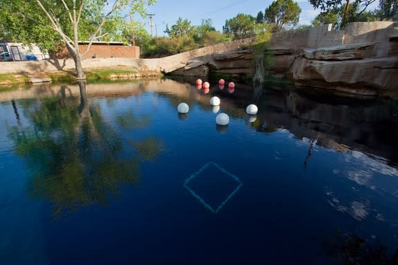 The surface of the "Blue Hole" in Santa Rosa, N.M. The balloons hold up underwater scuba stations used to train divers.