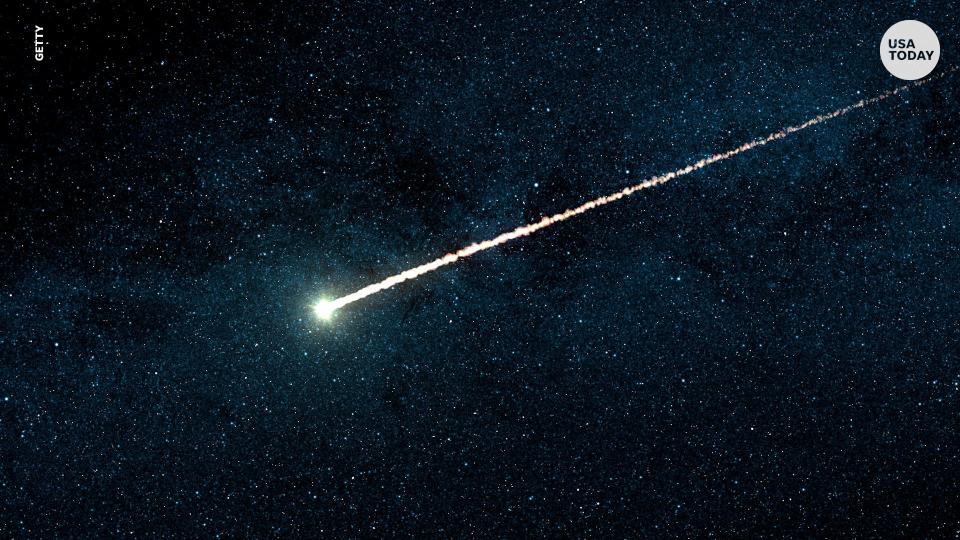 A fireball shoots across the night sky during the Orion meteor shower.