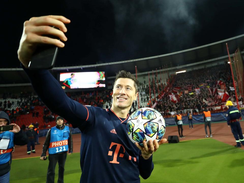 Robert Lewandowski celebrates with the matchball at full-time: Getty