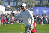 Tiger Woods holds up the ball after finishing his round on the 18th hole of the South Course at Torrey Pines Golf Course during the second round of the Farmers Insurance golf tournament Friday, Jan. 24, 2020, in San Diego. (AP Photo/Denis Poroy)