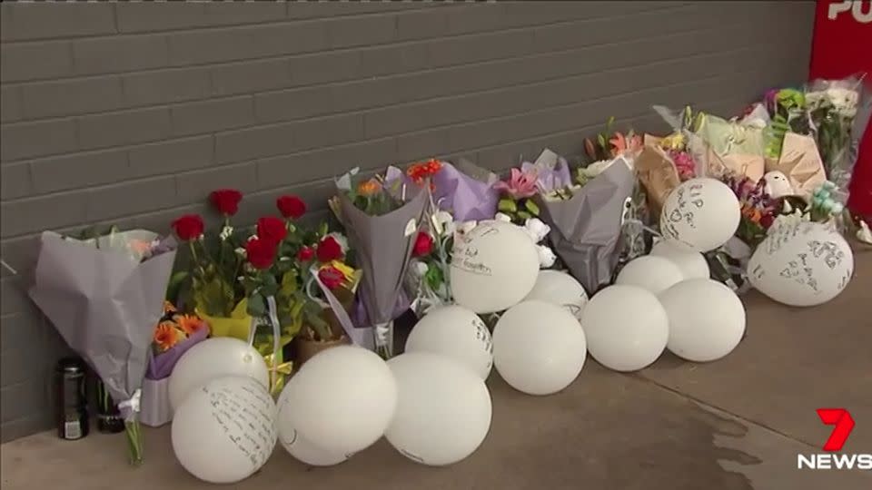 Friends and family paid tribute to the young father outside the shopping centre. Source: 7 News