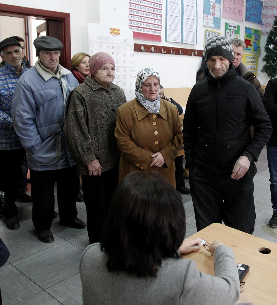 People wait to vote at a polling station in Tearce, northwestern Macedonia, Sunday, Dec. 25, 2016. Authorities in Macedonia have ordered a Christmas Day rerun of a parliamentary election in one voting district - a decision that could threaten the slim majority of the long-governing conservatives. (AP Photo/Boris Grdanoski)