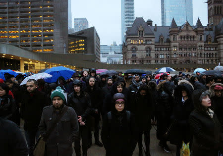 People attend a vigil for victims of the mosque shootings in New Zealand, outside city hall in Toronto, Ontario, Canada March 15, 2019. REUTERS/Chris Helgren