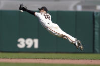 San Francisco Giants second baseman Tommy La Stella (18) dives but cannot reach a single by Colorado Rockies' Chi Chi Gonzalez during the fifth inning of a baseball game in San Francisco, Saturday, April 10, 2021. (AP Photo/Jeff Chiu)