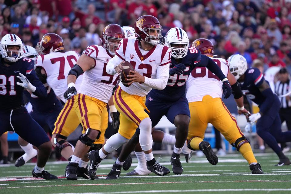 Southern California quarterback Caleb Williams (13) rolls out against Arizona during their 2022 game at Arizona Stadium.