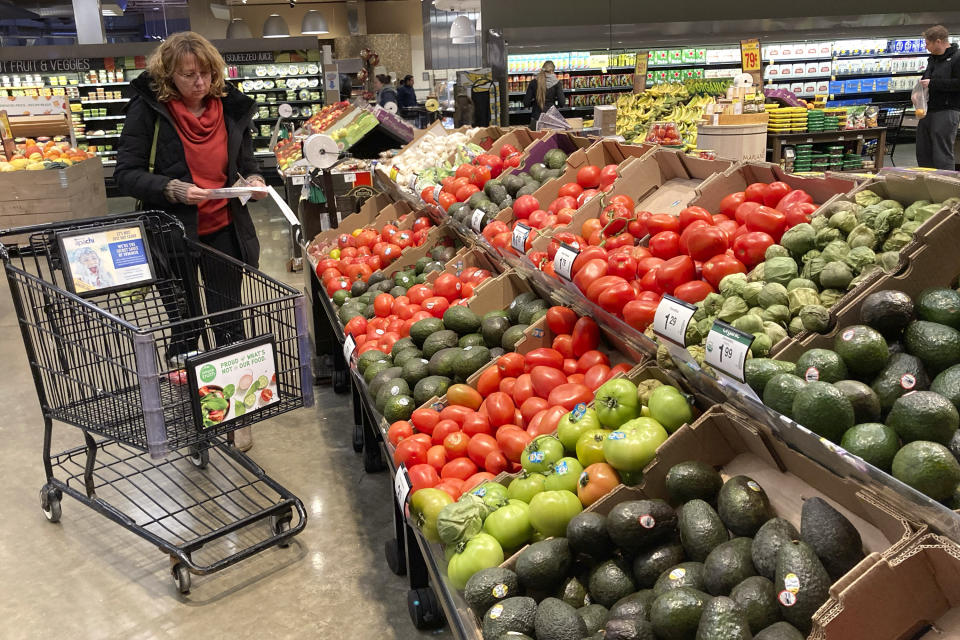 FILE - Shoppers pick out items at a grocery store in Glenview, Ill., Saturday, Nov. 19, 2022. The Federal Reserve is set to raise its benchmark short-term rate on Wednesday, Dec. 14, for a seventh time this year, though by a smaller amount than it has recently. (AP Photo/Nam Y. Huh, File)