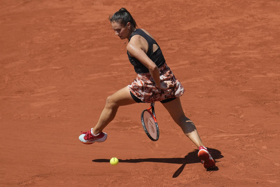 Russia's Daria Kasatkina plays a shot between her legs during the second round match of the French Open tennis tournament against Marketa Vondrousova of the Czech Republic at the Roland Garros stadium in Paris, Wednesday, May 31, 2023. (AP Photo/Christophe Ena)