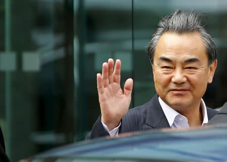 Chinese Foreign Minister Wang Yi gestures as he leaves Palais Coburg, the venue for nuclear talks in Vienna, Austria, July 13, 2015. REUTERS/Leonhard Foeger