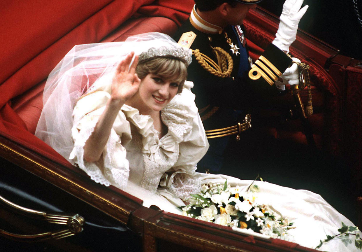 The Prince and Princess of Wales return to Buckingham Palace by carriage after their wedding, 29th July 1981. She wears a wedding dress by David and Elizabeth Emmanuel and the Spencer family tiara. (Photo by Terry Fincher/Princess Diana Archive/Getty Images)