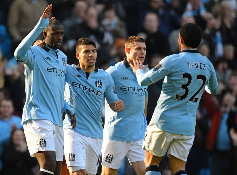 Manchester City midfielder Yaya Toure (L) celebrates with Sergio Aguero, James Milner and Carlos Tevez after scoring the opening goal of the fifth round English FA Cup football match against Leeds in Manchester on February 17, 2013. Manchester City's won 4-0