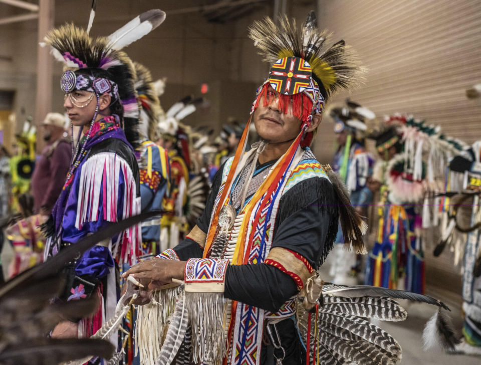 Darrell Vincenti, a Jicarilla Apache from Dulce, N.M., prepares for the grand entry with over a thousand dancers at the 40th anniversary of the Gathering of Nations Pow Wow in Albuquerque, N.M., Friday, April 28, 2023. The annual Gathering of Nations kicked off Friday with a colorful procession of Native American and Indigenous dancers from around the world moving to the beat of traditional drums as they fill an arena at the New Mexico state fairgrounds. (AP Photo/Roberto E. Rosales)