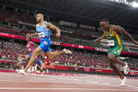 Lamont Jacobs, center, of Italy, celebrates after winning the men's the 100-meter final at the 2020 Summer Olympics, Sunday, Aug. 1, 2021, in Tokyo. (AP Photo/David J. Phillip)